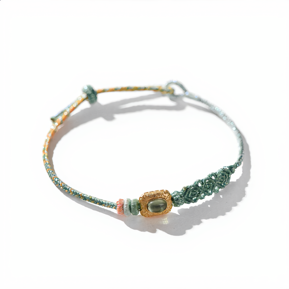 Handmade green cotton woven bracelet dyed with natural plant elements, featuring a central green tourmaline stone in a vintage gold setting woven with gold silk threads, Eastern Zen meditation jewelry.